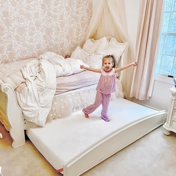 Little girl on her new Sealy mattress 