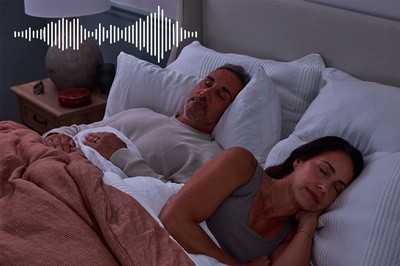couple sleeping with a sound machine