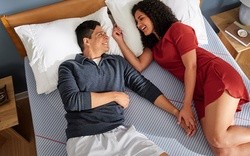 Couple laying on a Posturepedic Hybrid mattress