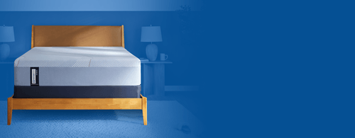 Posturepedic Hybrid mattress in a styled room with a blue background flipped