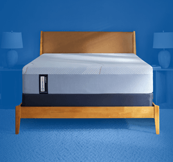 Posturepedic Hybrid mattress in a styled room with a blue background