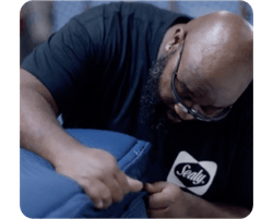 A man inspecting a Sealy mattress