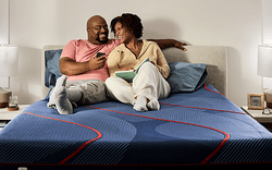 Couple laying on Posturepedic Elite Hybrid mattress